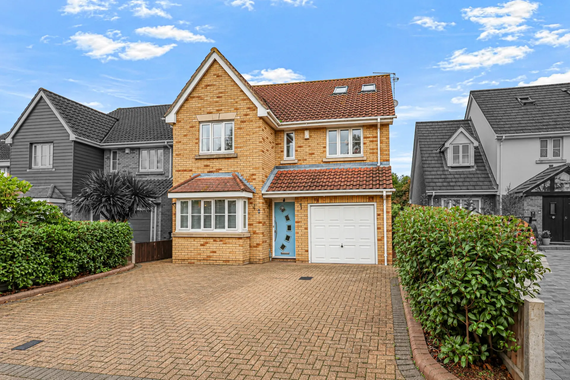 Detached brick home photographed from the front with the property in full colour