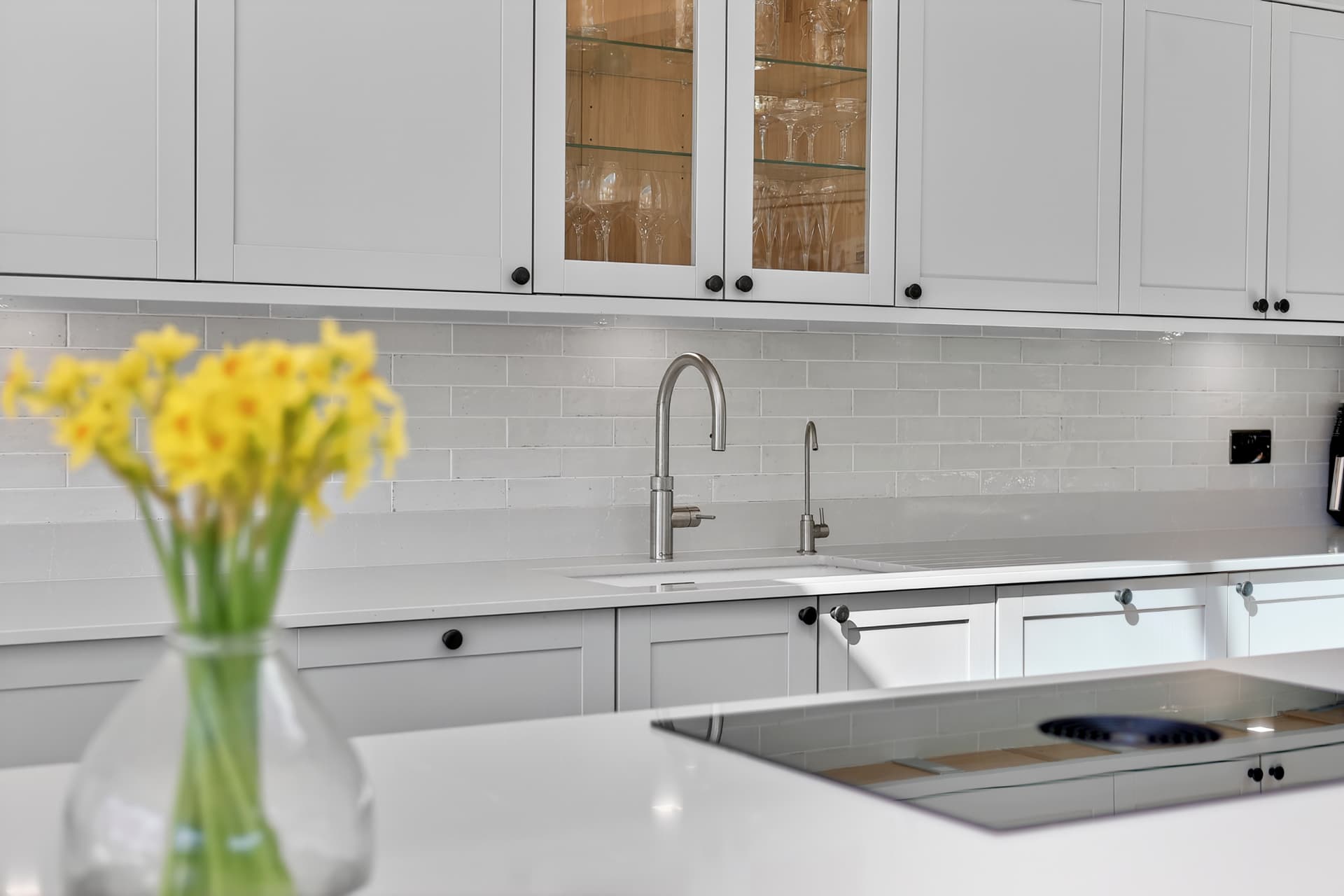 Bright shaker kitchen with quartz worktops photographed in HDR